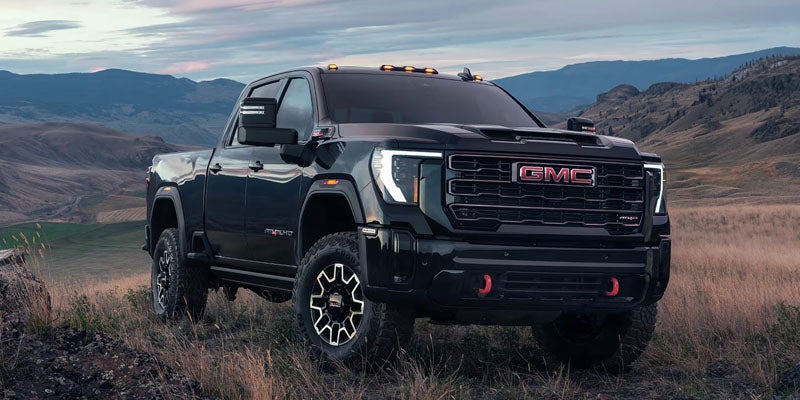 2026 GMC Sierra 2500 HD Pro parked outdoors showcasing its bold front design